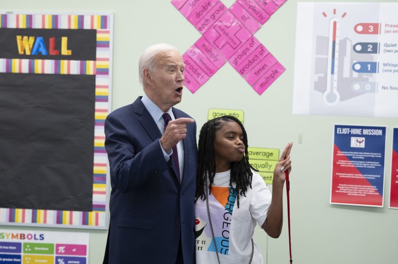President Joe Biden talks with a student as he and first lady Jill Biden welcome students back to school at Eliot-Hine Middle School in Washington, D.C. on Monday. Photo by Chris Kleponis/ UPI