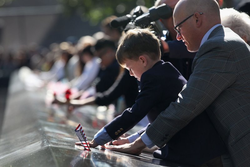 Andrew Timson, 7, etches the name of his slain uncle Andrew Fisher at ceremonies for the eleventh anniversary of the terrorist attacks on lower Manhattan at the World Trade Center on September 11, 2012 in New York City. UPI/John Moore/Pool
