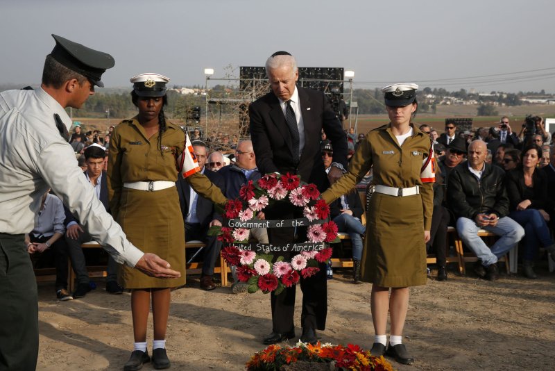U.S. Vice President Joe Biden (C) lays a wreath during the funeral of former Israeli Prime Minister Ariel Sharon near Sycamore Farm, Sharon's residence in southern Israel, January 13, 2014. Israel buried Sharon at his family farm on Monday, celebrating the military achievements of a man seen as a war hero at home but as a war criminal by many in the Arab world. Sharon, 85, died on Saturday after spending the last eight years of his life motionless in a hospital bed, pitched into a coma by a stroke and far from the public gaze. UPI/Baz Ratner/Pool