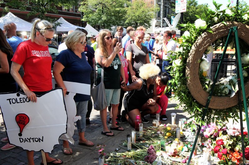 Protesters and mourners pray for the nine victims killed outside of Ned Peppers bar, the site of an August 4 mass shooting. Photo by John Sommers II/UPI | <a href="/News_Photos/lp/ec87952fac64e92593a83a80b0164a79/" target="_blank">License Photo</a>