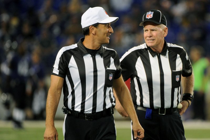 NFL officials Gene Steratore (L) and Bob Waggone talk on the field prior to the Baltimore Ravens' game against the Cleveland Browns on September 27, 2012 at M&T Bank Stadium in Baltimore. File photo by Kevin Dietsch/UPI