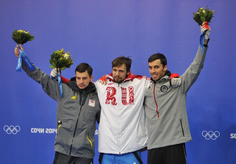 Latvia's Martins Dukurs (L-R), Russia's Alexander Tretiakov and United States' Matthew Antoine celebrate during the flower ceremony for the men's skeleton at the Sochi 2014 Winter Olympics in Krasnaya Polyana, Russia, Feb. 15, 2014 in Russia. Tretiakov won gold, Dukers silver and Antoine bronze in the event. UPI/Brian Kersey | <a href="/News_Photos/lp/943fe508f69b16e06659753f11cfb637/" target="_blank">License Photo</a>