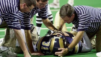 SLP2001120917- 09 DECEMBER 2001- ST. LOUIS, MISSOURI, USA: St. Louis Rams trainers hover over safety Adam Archuleta after a collision with the San Francisco 49ers in the fourth quarter, at the Dome At America's Center in St. Louis, Missouri, December 9, 2001. Archuleta cam out of the game with a slight concussion. mk/bg/Bill Greenblatt UPI