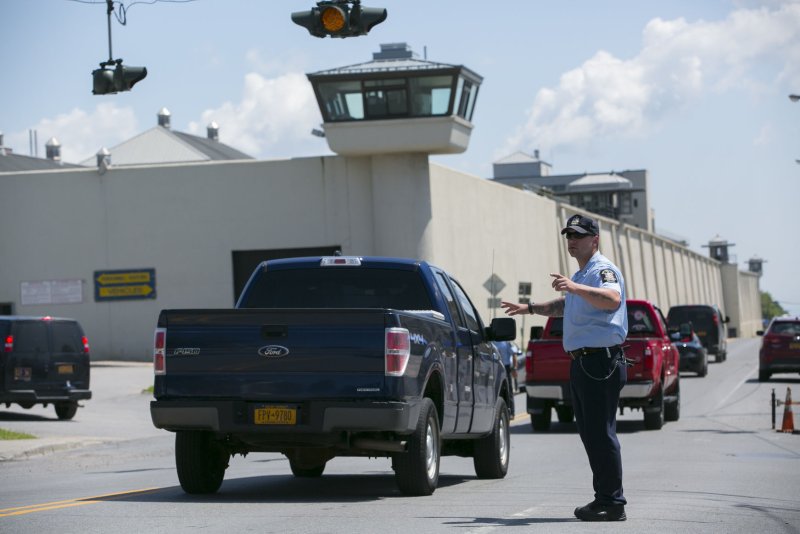 A Guard from the New York State Department of Corrections and Community Supervision directs traffic in front of the Clinton Correctional Facility in Dannemora, New York, June 13, 2015. Thursday, the maximum security prison lifted a lockdown that had been in place since David Sweat and Richard Matt escaped on June 6. Photo by Matthew Healey/UPI | <a href="/News_Photos/lp/34e6d914cb72ebbfa0e3f2c2cdde2876/" target="_blank">License Photo</a>