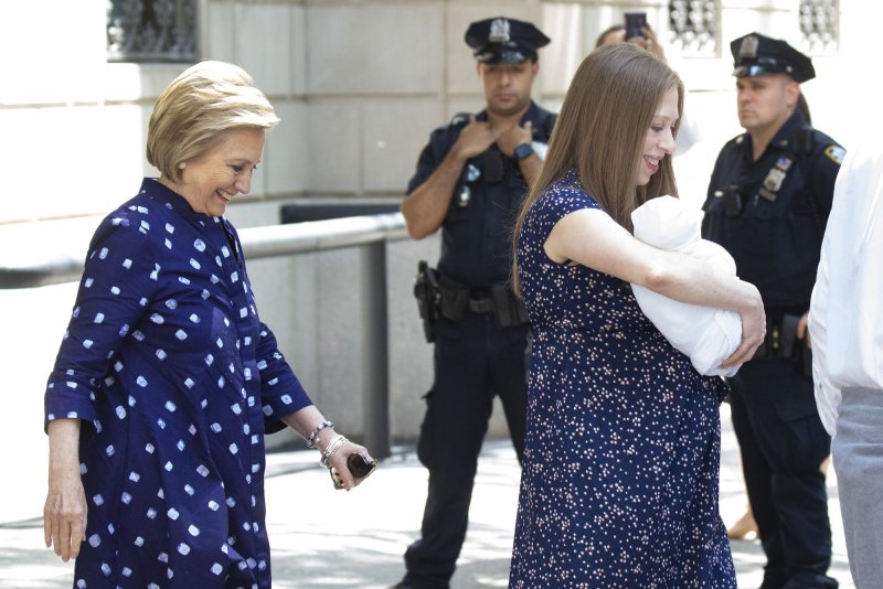 Chelsea Clinton (R) leaves Lenox Hill Hospital with her baby boy, Jasper, and mom Hillary Clinton (L) on Thursday. Photo by John Angelillo/UPI