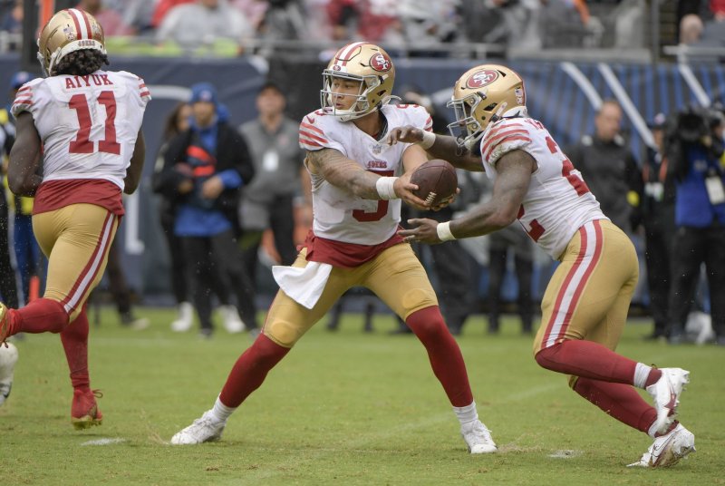 San Francisco 49ers quarterback Trey Lance (C) hands off the ball to running back Jeff Wilson Jr. in the third quarter of a loss to the Chicago Bears on Sunday at Soldier Field in Chicago. Photo by Mark Black/UPI | <a href="/News_Photos/lp/ebac5b7a074e4d0598c802034dbb5fec/" target="_blank">License Photo</a>