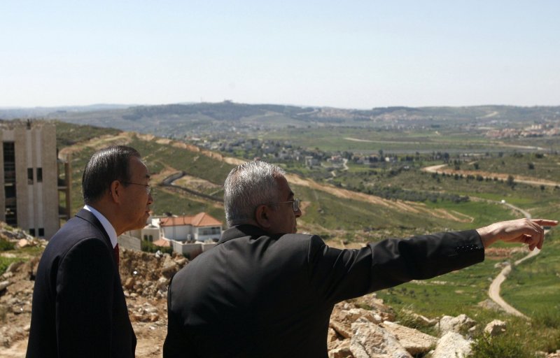 United Nations Secretary General Ban ki-Moon (L) and Palestinian Prime Minister Salam Fayyad look over the controversial Israeli barrier in the distance during a tour in Ramallah, West Bank on March 20, 2010. The U.N. Chief Ban ki-Moon said that Israeli settlement building undermines peace efforts. UPI/Mohamad Torokman/Pool