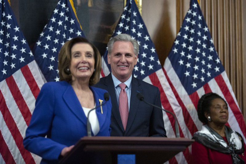 House Minority Leader Kevin McCarthy listens as House Speaker Nancy Pelosi talks during a signing ceremony after the House passed the $2.2 trillion CARES Act amid the onset of the COVID-19 pandemic in March 2020. File Photo by Stefani Reynolds/UPI