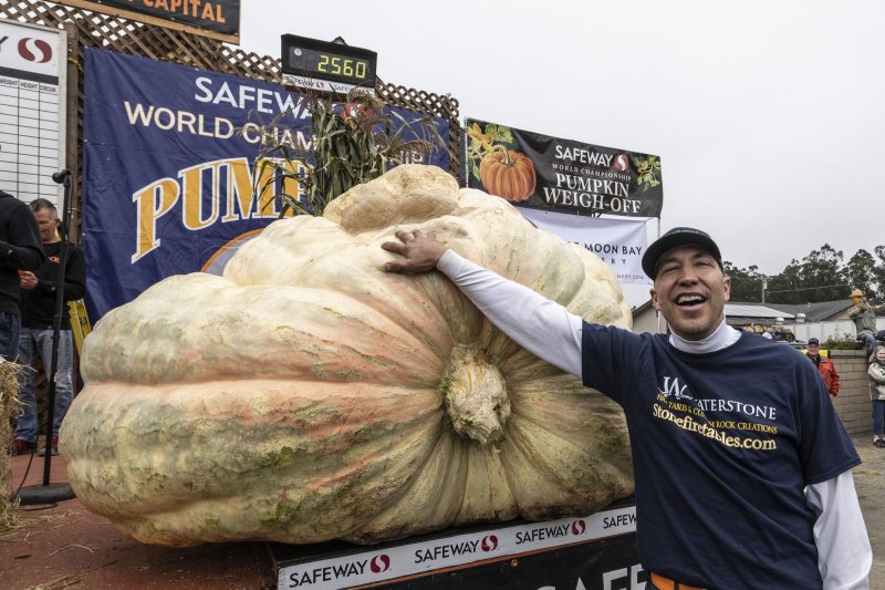 Travis Gienger of Anoka, Minn., poses with his 2,560 pound winner at the World Championship Pumpkin Weigh-off in Half Moon Bay, Calif., on Monday. File Photo by Terry Schmitt/UPI | <a href="/News_Photos/lp/349a1e173c0d3a152da7515aa1873402/" target="_blank">License Photo</a>