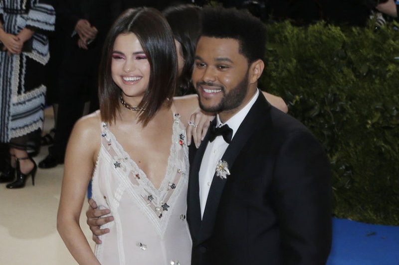 The Weeknd (R), pictured with Selena Gomez, purged the actress from his Instagram account Tuesday. File Photo by John Angelillo/UPI