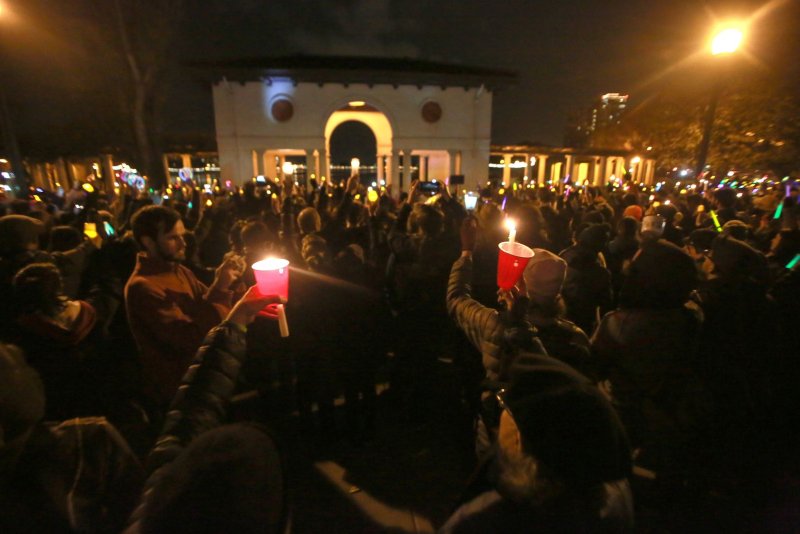 Participants hold candles at a vigil by Oakland's Lake Merritt for victims of a fire at a warehouse known as The Ghost Ship in California on December 5, 2016. The man who rented the warehouse pleaded guilty to 36 counts of involuntary manslaughter Friday. File Photo by Khaled Sayed/UPI