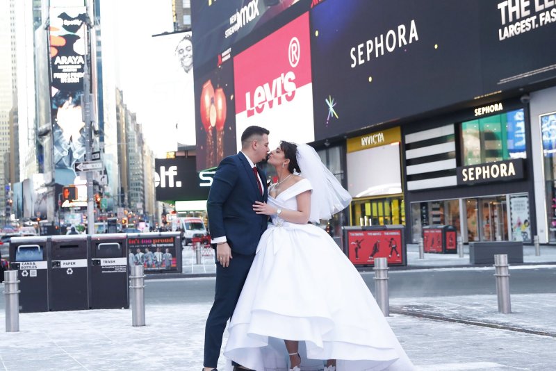 A bride and groom take photos in Times Square in New York City earlier this year. Photo by John Angelillo/UPI | <a href="/News_Photos/lp/7a3954e7f891d87fa3ff6613f04f3377/" target="_blank">License Photo</a>