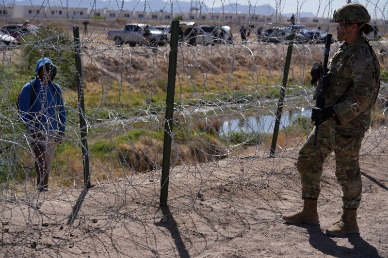 Members of the Operation Lone Star Task Force West and Texas Tactical Border Force block migrants from illegally entering Texas in May near El Paso on the Rio Grande River. File Photo by Mark Otte/Texas Army National Guard