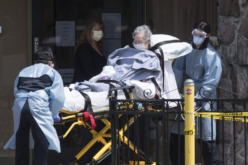 A patient is moved out of Gateway Care and Rehabilitation Center, a skilled nursing facility in Hayward, Calif., on April 9. Photo by Terry Schmitt/UPI