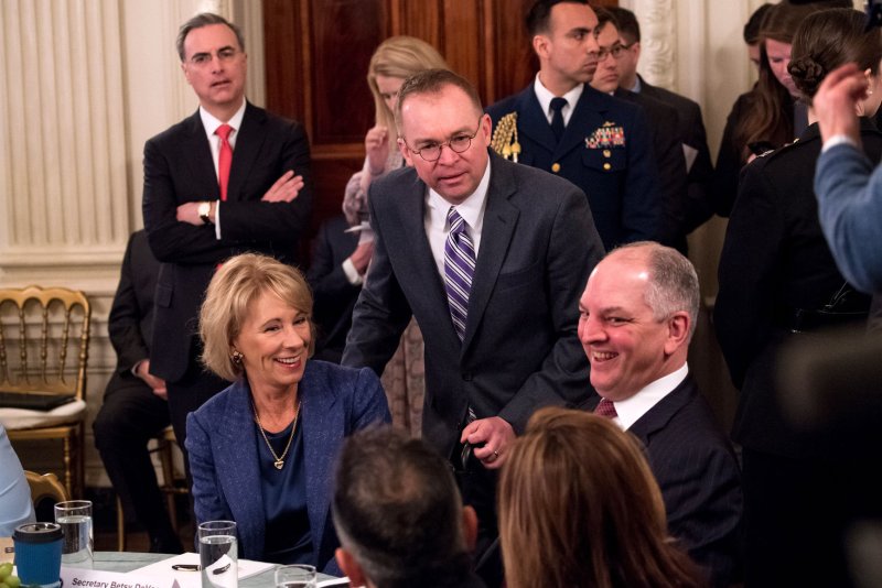 Louisiana Gov. John Bel Edwards, (R) pictured sitting next to former Education Secretary Betsy DeVos at the White House in February 2019, has vetoed congressional district maps drawn by the GOP controlled Louisiana legislature. Photo by Kevin Dietsch/UPI | <a href="/News_Photos/lp/3531b76ca6f89fc15a3c33df0598b74e/" target="_blank">License Photo</a>