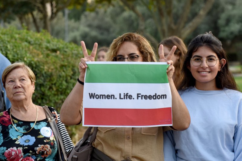 Israelis hold placards in support of Iranian woman Mahsa Amini during a solidarity protest in Jerusalem on October 6, 2022. Amini, 22, died after detained by the morality police in Iran. File Photo by Debbie Hill UPI