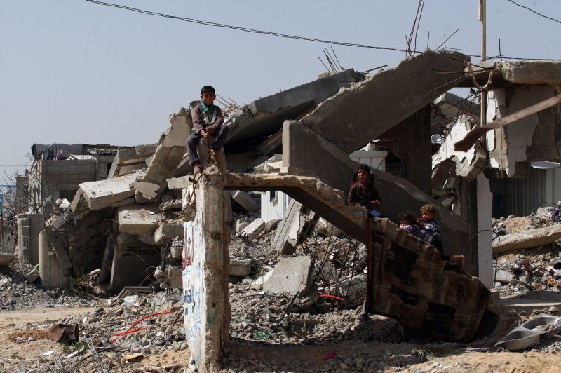 Palestinian boys play on buildings destroyed, on the remains of a house that crumbled during the 50-day war between Israel and Hamas militants in the summer of 2014, on March 01, 2015. File Photo by Ismael Mohamad/UPI.