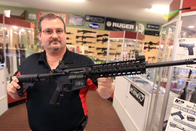 A gun shop owner in Bridgeton, Mo., shows a Smith &amp; Wesson AR-15 assault rifle at his store. Smith &amp; Wesson rifles have been used in several deadly mass shooting attacks. File Photo by Bill Greenblatt/UPI | <a href="/News_Photos/lp/c69c65dd48c923eb85bbd358f00a5ad8/" target="_blank">License Photo</a>