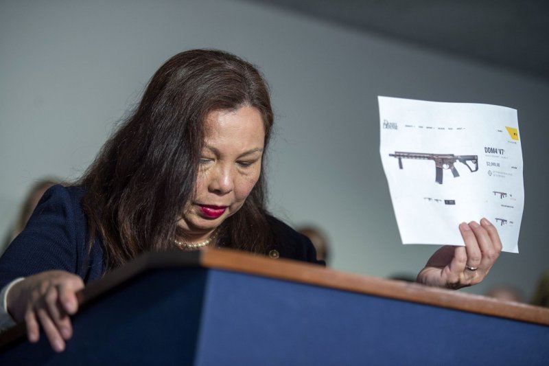 Sen. Tammy Duckworth, D-Ill, holds a sign showing the price of an automatic weapon during a press conference after a Senate Judiciary Committee hearing entitled 'After the Highland Park Attack: Protecting Our Committees from Mass Shootings' at the U.S. Capitol in Washington, DC in July 2022. File Photo by Bonnie Cash/UPI