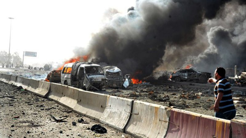 A handout picture released by the Syrian Arab News Agency (SANA) shows burning vehicles at the site of twin suicide bomber blasts in Damascus on May 10, 2012. UPI