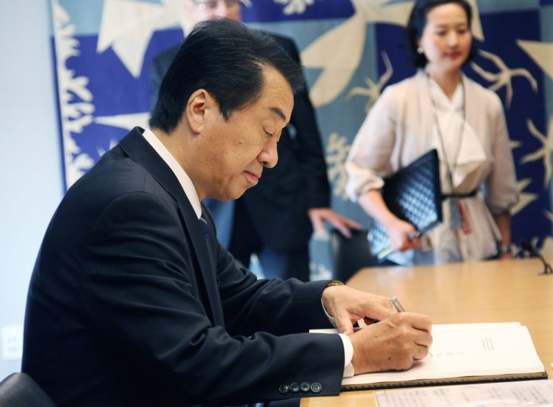Japan's Prime Minister Naoto Kan signs the guest book before his meeting with Secretary General Ban Ki-moon during the 65th session of the United Nations General Assembly at the UN on September 24, 2010 in New York. UPI/Monika Graff