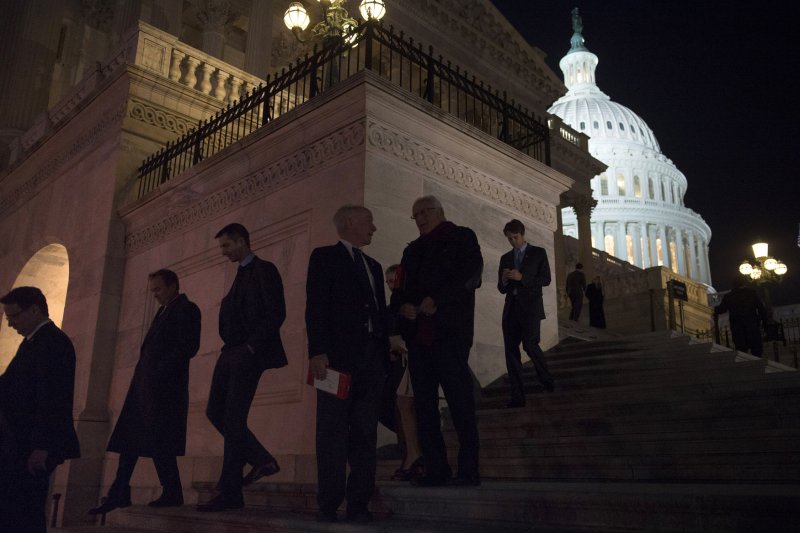 Members of Congress leave the House of Representatives after voting on the House budget bill before recessing for the year, on Capitol Hill in Washington, D.C. on December 12, 2013. The House passed the bipartisan budget deal 332-94 and also passed a Pentagon bill that would strengthen protections for victims of sexual assault. UPI/Kevin Dietsch