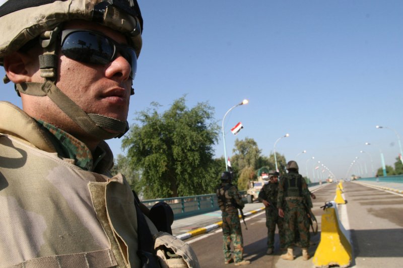 An Iraqi soldier stands guard during the reopening of the Al-Aima bridge which spans the Tigris River linking the centuries-old neighborhoods of Kadhimiyah and Adhamiyah on November 11, 2008, in Baghdad. Authorities in Baghdad opened the bridge linking historic Sunni and Shiite districts that was closed in 2005 after nearly 1,000 Shiite pilgrims perished in a deadly stampede. File Photo by Ali Jasim/UPI