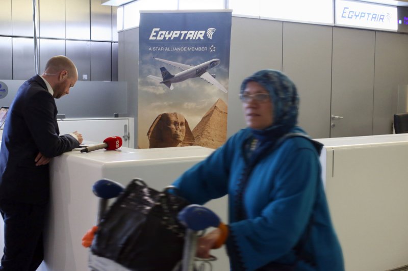 A traveller walks past the the EgyptAir counter in the departure hall of Charles de Gaulle Airport in Paris, a day after Flight MS804 crashed. French authorities are investigating whether the copilot's overheating cellphone or tablet caused a fire that brought down the plane, killing all 66 people aboard. File Photo by Eco Clement/UPI