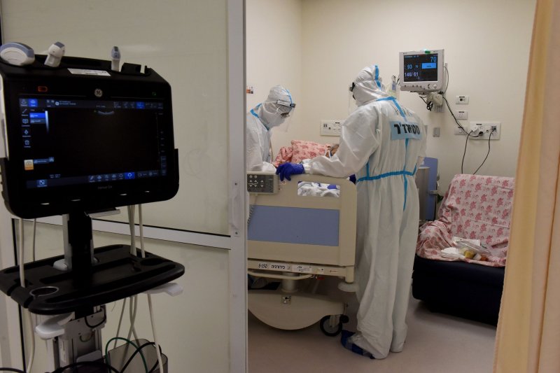 Israeli medical staff wear full protective suits while treating a patient in the intensive care unit of the COVID-19 ward in the Shaare Tzedek Medical Center in Jerusalem in October 2020. File Photo by Debbie Hill/UPI