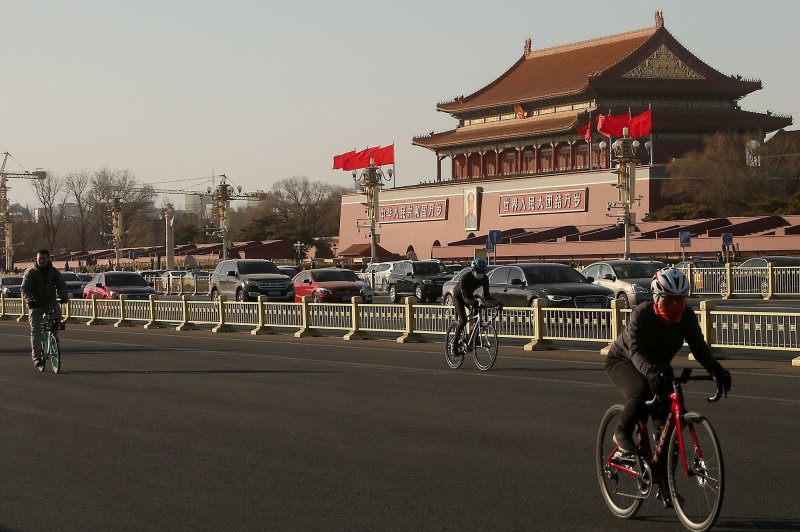 Chinese cycle past Tiananmen Square's North Rostrum in Beijing on February 3, 2021, amid a partial lockdown imposed due to the threat of COVID-19 in the capital. File Photo by Stephen Shaver/UPI