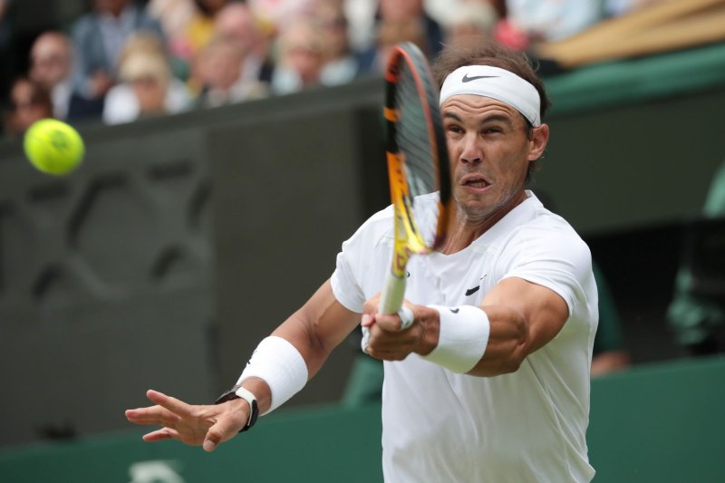 Spain's Rafael Nadal plays a forehand against American Taylor Fritz at Wimbledon on Wednesday in London. Photo by Hugo Philpott/UPI | <a href="/News_Photos/lp/978a4e22f37cabf48917c71b0f632aef/" target="_blank">License Photo</a>