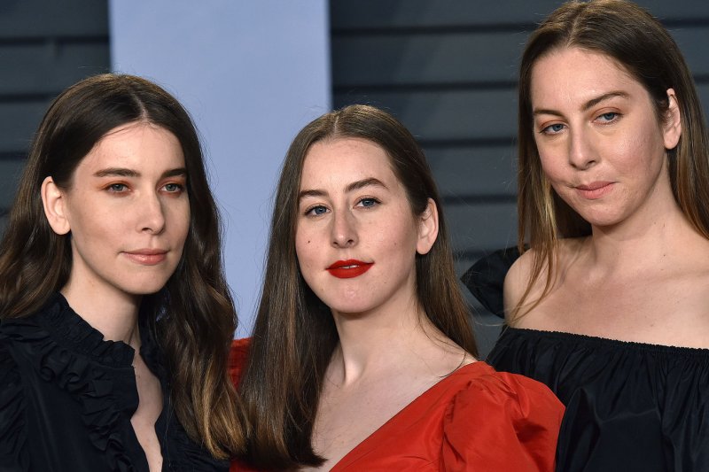 Left to right, Danielle, Alana and Este of Haim arrive for the Vanity Fair Oscar Party in March 2018. Alana Haim stars in the new trailer for "Licorice Pizza." File Photo by Christine Chew/UPI