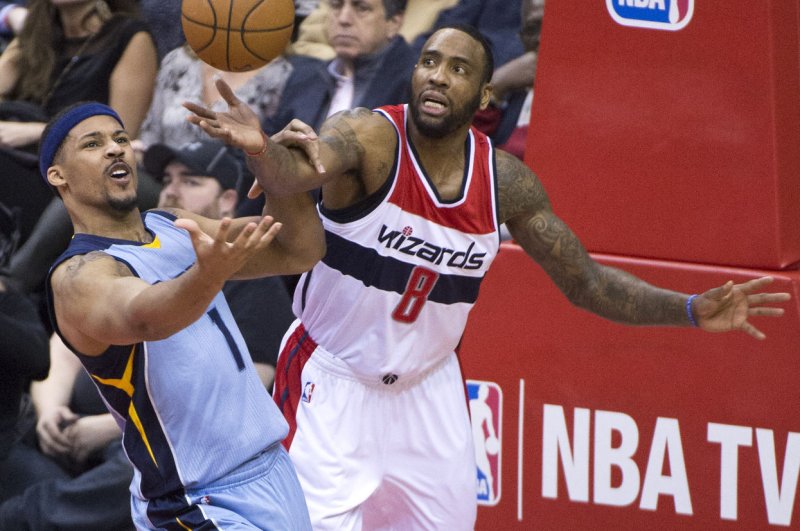 Washington Wizards forward Rasual Butler and former Memphis Grizzlies forward Jarnell Stokes first for the ball during the second quarter at the Verizon Center in Washington, D.C. on March 12, 2015. Photo by Kevin Dietsch/UPI