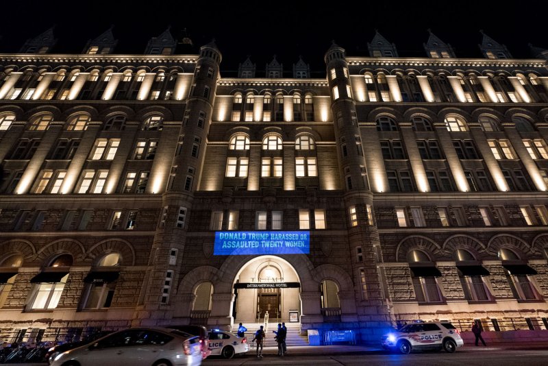 A message in opposition to President Donald Trump is flashed above the front door of Trump International Hotel in Washington on January 30, 2018. A federal judge allowed a case to proceed on Wednesday in which Trump, as owner of the hotel, is accused of violating the U.S. Constitution's emoluments clause. Photo by Erin Schaff/UPI