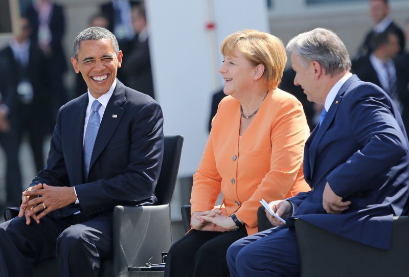 U.S. President Barack Obama (L), German Chancellor Angela Merkel (C) and Berlin Mayor Klaus Wowereit arrive at the Brandenburg Gate in Berlin on June 19, 2013. Obama is in Berlin on his first official state visit to Germany and spoke at the historic site where fifty years earlier U.S. President John F. Kennedy delivered his famous "Ich bin ein Berliner (I am a Berliner)" address . UPI/David Silpa