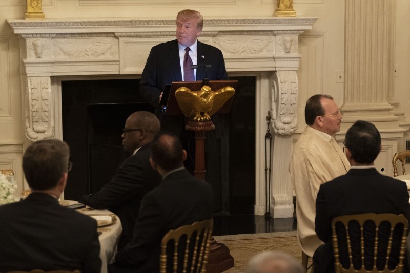 President Donald Trump speaks to guests, including prominent Muslims, in the White House during the iftar dinner Monday night. Photo by Chris Kleponis/UPI