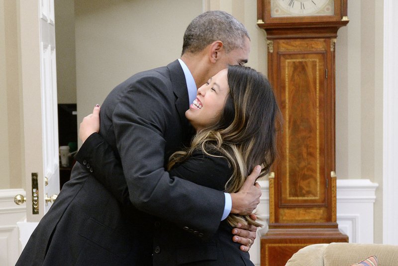 President Barack Obama hugs Ebola victim Dallas nurse Nina Pham in the Oval Office of the White House. UPI/Olivier Douliery/Pool