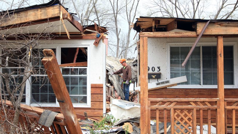 A tree removal workman surveys a tornado damaged neighborhood in Hazelwood, Missouri on April 11, 2013. UPI/Bill Greenblatt | <a href="/News_Photos/lp/2775569d61103db4200d4b483f57c301/" target="_blank">License Photo</a>