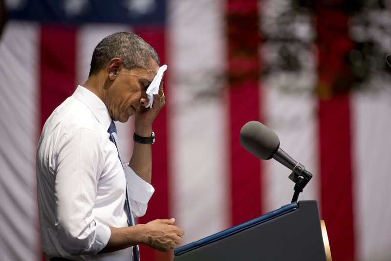 President Barack Obama wipes sweat from his face as he delivers remarks on climate change and new environmental standards, on the campus of Georgetown University on June 25, 2013 in Washington, D.C. UPI/Kevin Dietsch | <a href="/News_Photos/lp/14cd6d4860b1ad453da0e6c6506f62dd/" target="_blank">License Photo</a>