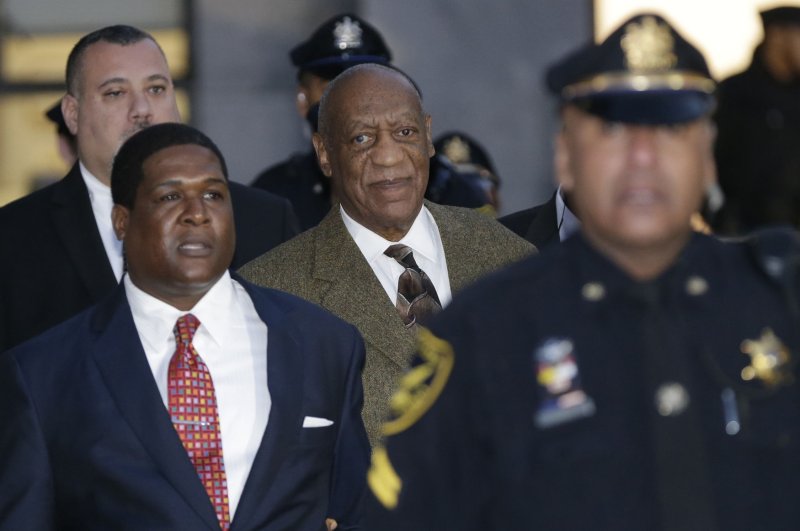 Entertainer Bill Cosby (C) is escorted from Montgomery County Courthouse from his first hearing in the aggravated assault case against him in Norristown, Pa., on February 2, 2016. Jury selection in his trial begins Monday. Photo by John Angelillo/UPI