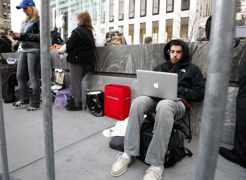 Sina Azmoudeh of Dallas sits near the front of the line at the Apple Store on Fifth Avenue on the eve of the April 3 release of the new Apple iPad in New York City. Generation Y loves technology and members will use it to improve their economic prospects. UPI/John Angelillo