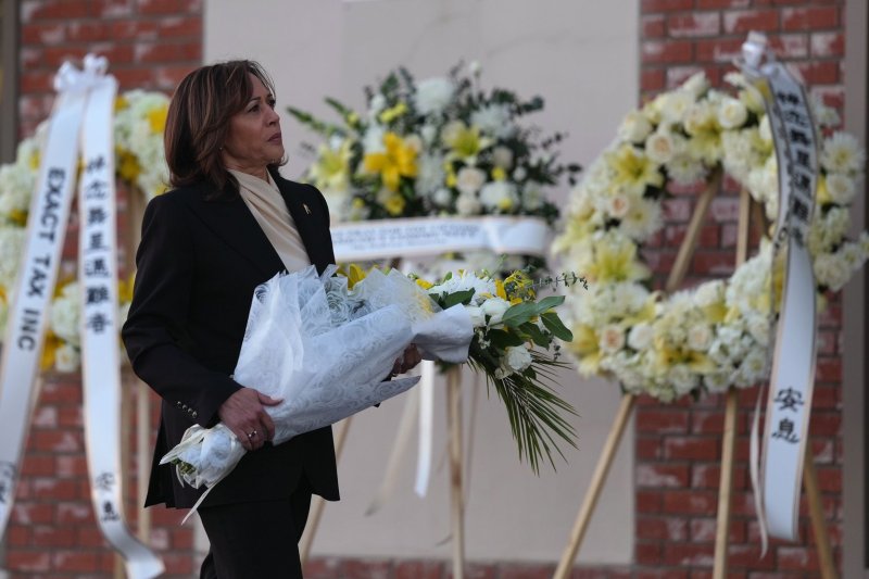 Vice President Kamala Harris carries flowers as she pays her respects to the victims of a mass shooting at Star Dance Studio in Monterey Park, Calif., on Wednesday. Harris is visiting a memorial and families of a mass shooting that happened Saturday 21, 2023, leaving 11 dead and 10 injured. Photo by Allison Dinner/UPI