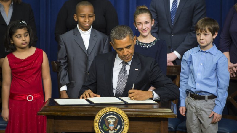 Flanked by school children, U.S. President Barack Obama signs executive orders to control gun violence in the South Court Auditorium on January 16, 2013 in Washington, DC. The president also called on congress to pass legislation to curb gun violence, one month after a school massacre in Newtown, Connecticut that killed 20 students and six adults. The children L-R: Hinna Zeejah, Taejah Goode, Julia Stokes and Grant Fritz. UPI/Pat Benic | <a href="/News_Photos/lp/a1831ce83badfb0fc63178fc43657e2d/" target="_blank">License Photo</a>