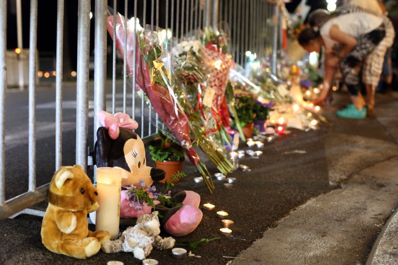Flowers, candles and teddy bears line up the Promenade des Anglais as people mourn at night in Nice, southern France, on 17 July, 2016, after 86 people were killed and more than 400 were injured when a truck mowed down a crowd of revelers attending the Bastille Day fireworks. File Photo by Maya Vidon-White/UPI | <a href="/News_Photos/lp/4656f53951147d8695216aa196fbc76c/" target="_blank">License Photo</a>