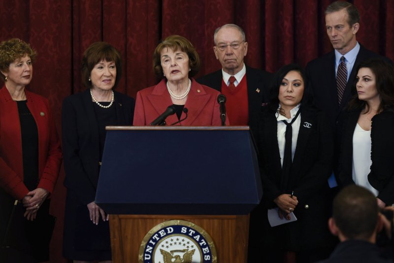 Sen. Dianne Feinstein, D-Calif., (C) speaks at a news conference with sexual abuse survivors Tuesday in Washington, D.C.. Participants, from left to right, included Rep. Susan Brooks, R-Ind., Sen. Susan Collins, R-Maine, Senate Judiciary Chairman Charles Grassley, R-Iowa, John Thune, R-S.D., and former USA gymnastics national team members Jamie Dantzscher and Jeanette Antolin. Photo by Leigh Vogel/UPI