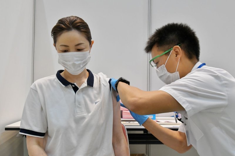 A medical worker administers the COVID-19 vaccine at the Japan Self-Defense Forces' large-scale COVID-19 vaccination centers in Osaka, Japan, in June. On Thursday, more than 1.6 million doses of the Moderna vaccine were removed for the country's vaccine drive over contamination concerns. File Photo by Keizo Mori/UPI