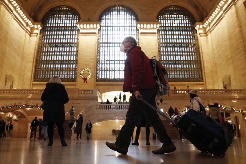 Travelers and commuters walk through the Grand Central Terminal in New York City on Wednesday. For the second straight year, holiday plans are being affected due to a surge in Omicron COVID-19 infections. Photo by John Angelillo/UPI