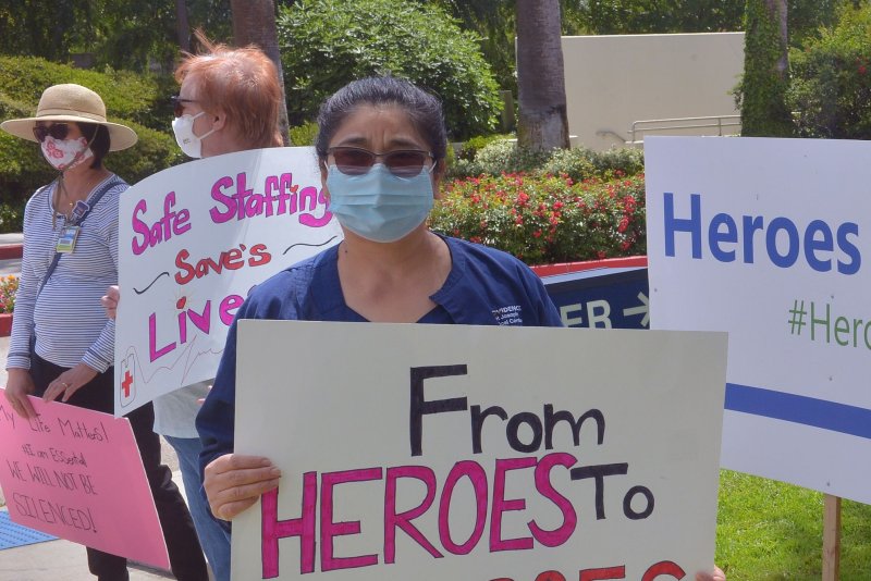 A small group of employees picket outside the Providence St. Joseph Medical Center in Burbank, Calif., on May 19, 2020. The picketers claim management is putting their health and safety at risk because of lax protocols around the treatment of COVID-19 patients, a lack of personal protective equipment and short-staffing. File Photo by Jim Ruymen/UPI