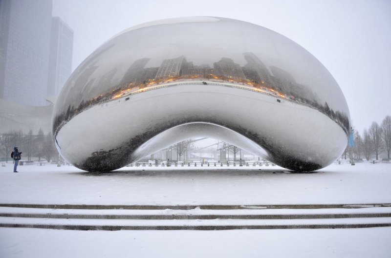 A person looks at the Cloud Gate sculpture in Millennium Park as a major snow storm hits on February 1, 2011 in Chicago. Up to 11 inches of new snow is expected to fall in the Chicago area on Tuesday. UPI/Brian Kersey
