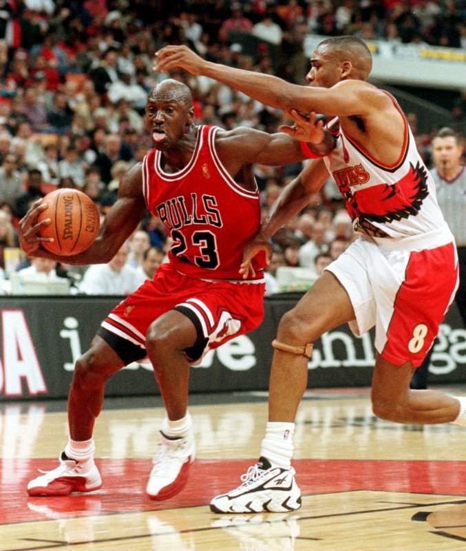 Chicago Bulls Michael Jordan drives past Atlanta Hawks Steve Smith for a layup during the second period February 14, 1997, in Atlanta. The Bulls ended Atlanta's winning streak at 20 games with a 89-88 victory. On March 18, 1995, "I'm back." Superstar Michael Jordan announced he was returning to professional basketball and the Chicago Bulls after a 17-month break. File Photo by Jim Middleton/UPI